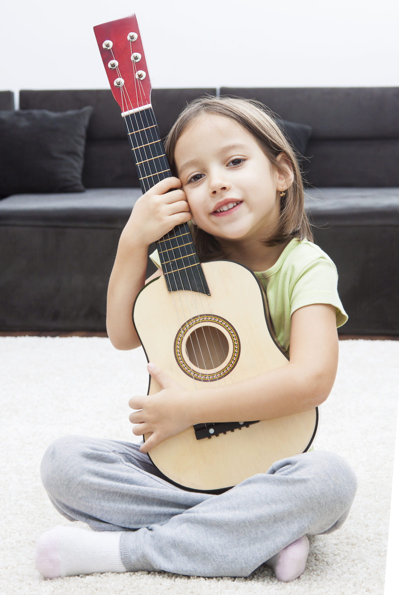 Stock photo of a smiling girl with a guitar
