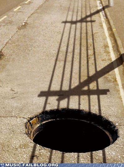 When shadows and holes in the street converge to look like a guitar