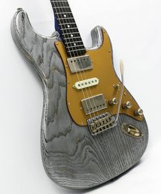 Grey body Strat with amazing wood grain lines and gold colored pick guard