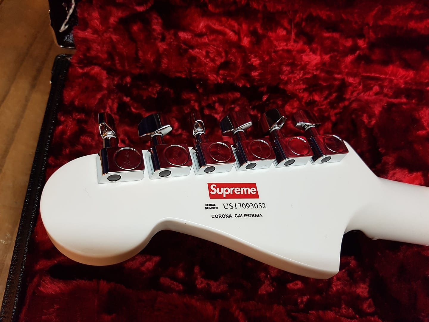 This is the headstock of the all-white Stratocaster. If only it didn't have the darn red "Supreme" logo between the picks, which diminishes the guitar's beauty