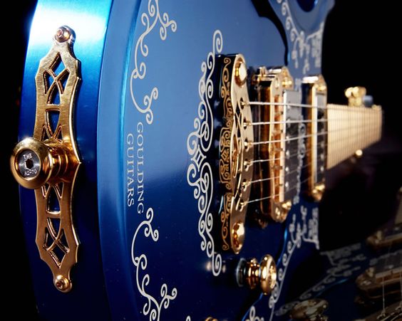 Deep blue guitar with silver inlays and gold hardware. This is my favorite type of blue. 
