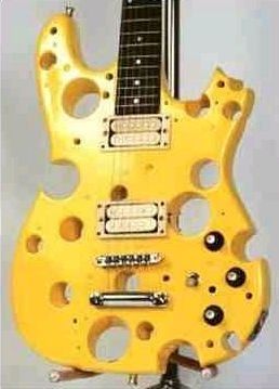 It has the holes, the color and everything. Totally looks like a hunk of cheese with a guitar neck on it. 