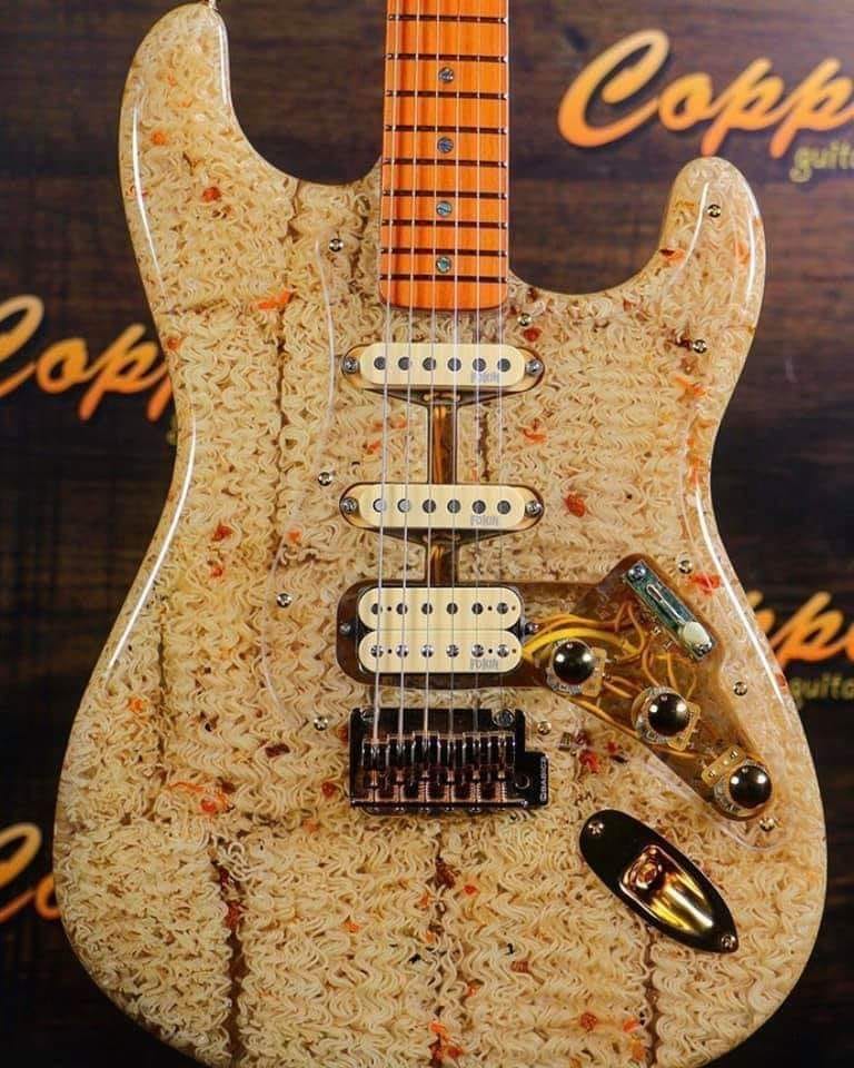 Now, THAT is amazing. Not sure if the ramen noodles are printed on the guitar, or if this is a see-through guitar filled up with blocks of Ramen noodles