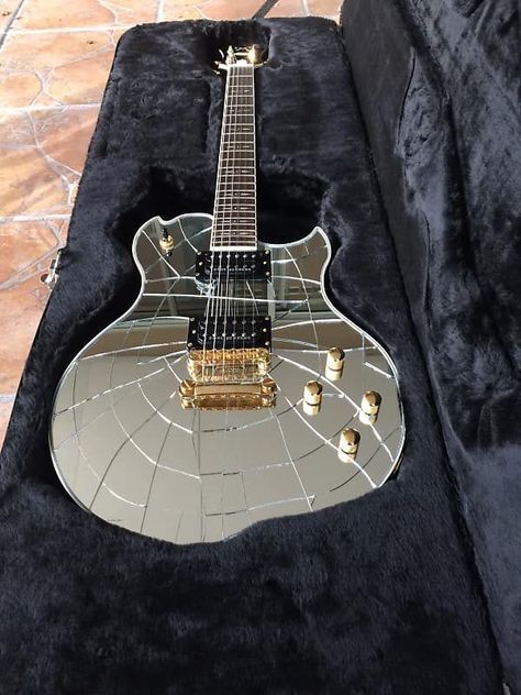 Looks like a guitar Kiss would play. Cracked mirror/chrome guitar, black pick ups and gold hardware