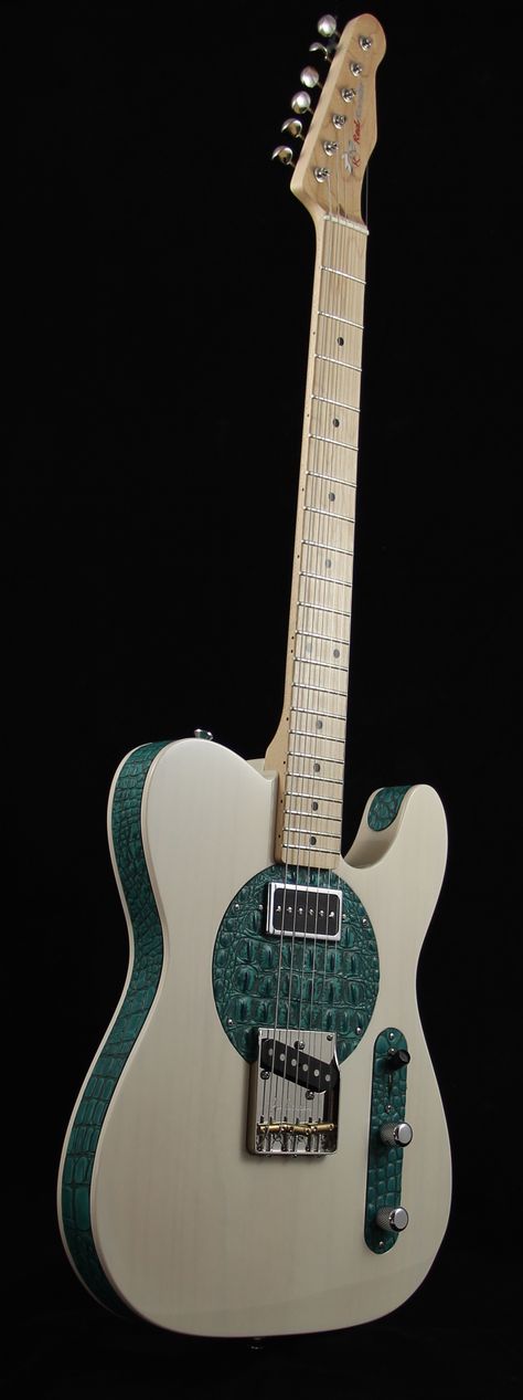 This really beautiful guitar has a white body with teall edges, and areas. 