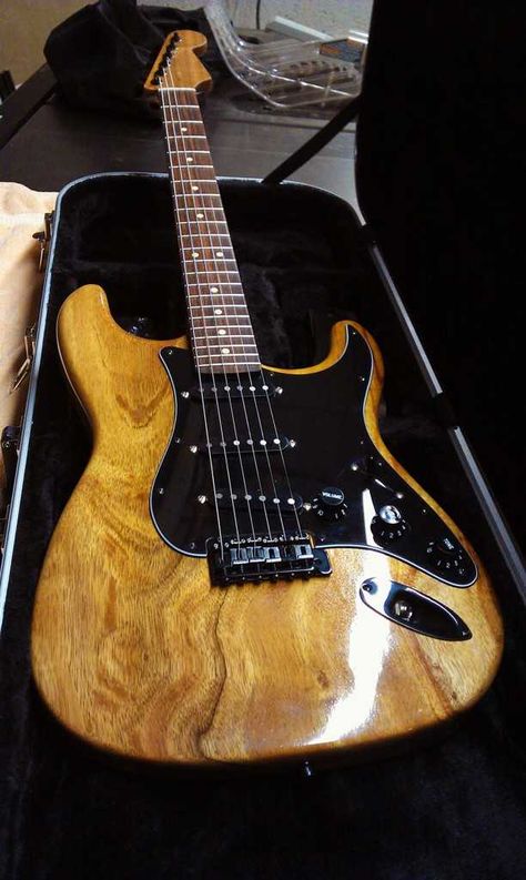 An exotic wood Fedner Strat with natural finish and all black accessories