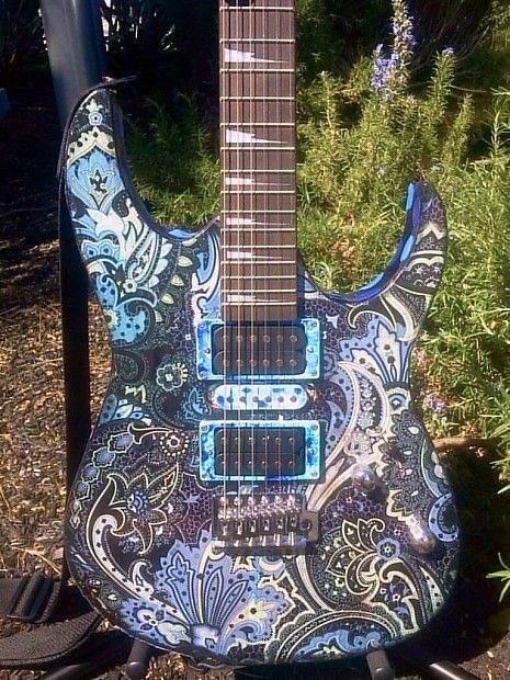 Sparkly psychedelic blue guitar paint job