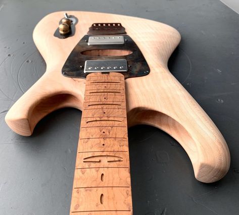 50s Space model natural wood with triangular center pick guard. 