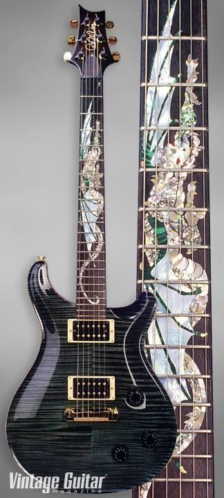 Black trans finish, maple flames, big pearl or abalon neck inlay, gold hardware