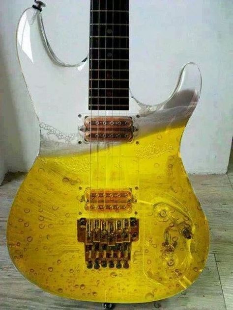 I can't tell if this is a white guitar with a beer paint job, or if this guitar body is filled up with beer