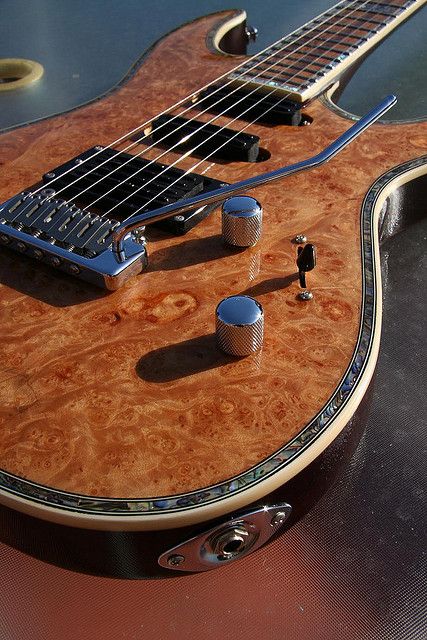 Ornate burl grain guitar wtih abelone or pearl binding. Stunningly beautiful