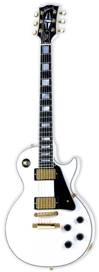 A shiny Snow White Les Paul with gold hardware and black knobs and pick up cover