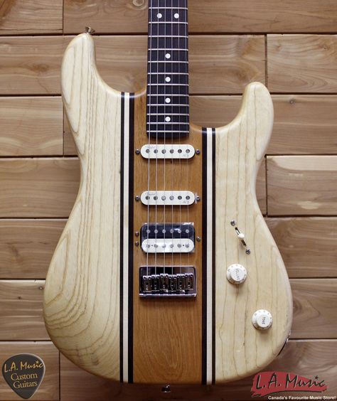 This natural wood guitar with lines running along the length of the guitar body, are similar to the lines in a sportscar. 