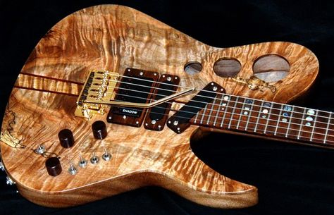 This custom guitar with gorgeous Burl wood, packs a vast number of switches, knobs and options